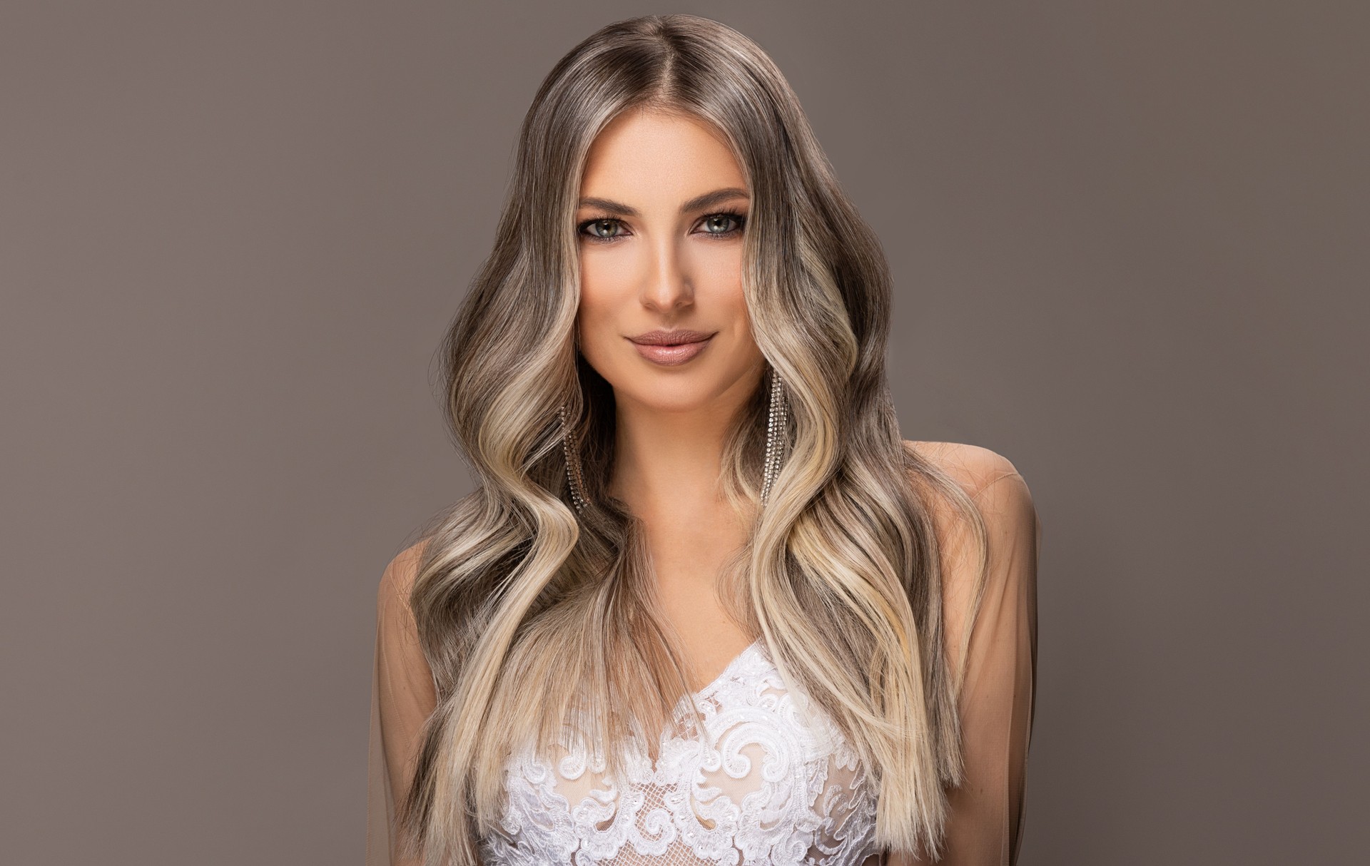 Attractive woman with well groomed hair,dyed in a deep ash shade with the pale blonde locks. Hairdressing art and hair coloring.